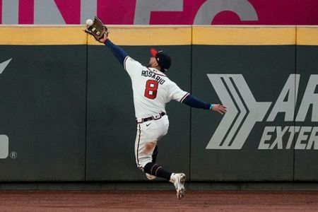 Hall of Famer and former Atlanta Braves pitcher Greg Maddux throws out the  ceremonial first pitch before Game 5 of the World Series between the  Atlanta Braves and the Houston Astros on