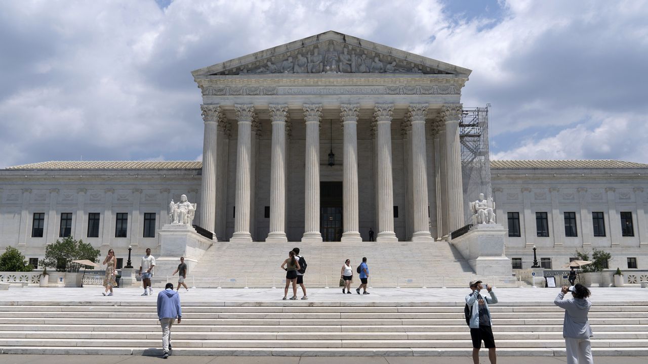 Visitors pose for photographs outside the U.S. Supreme Court Tuesday, June 18, 2024, in Washington. ( AP Photo/Jose Luis Magana)