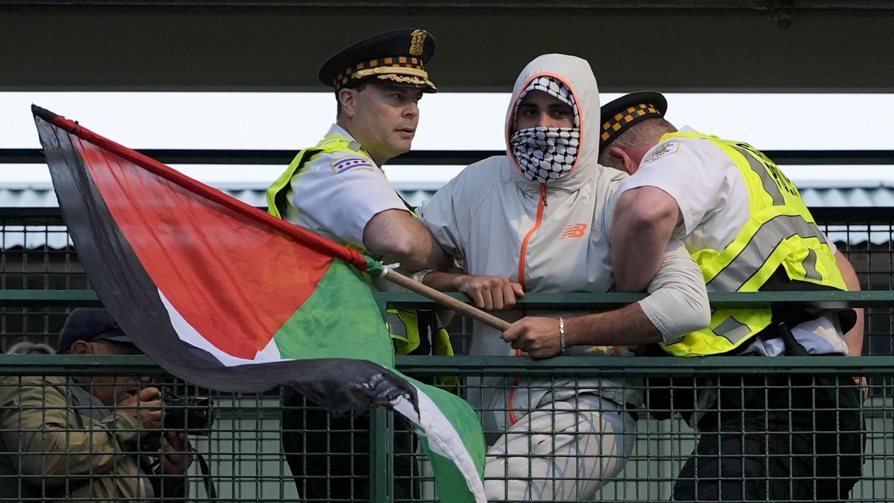 Police detain a protester during a demonstration outside the Democratic National Convention Wednesday, Aug. 21, 2024, in Chicago. (AP Photo/Alex Brandon)