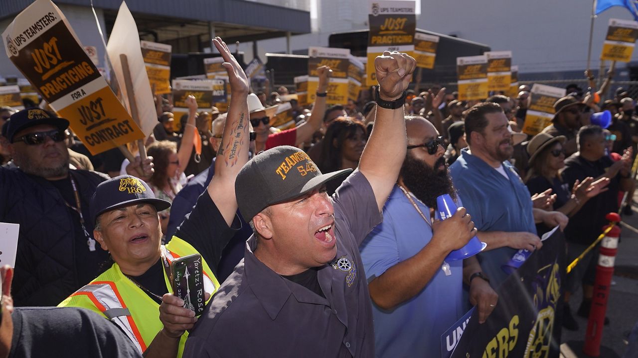 Teamsters and workers hold a rally in downtown Los Angeles, July 19, 2023, as a deadline neared in negotiations between the union and United Parcel Service. (AP Photo/Damian Dovarganes)