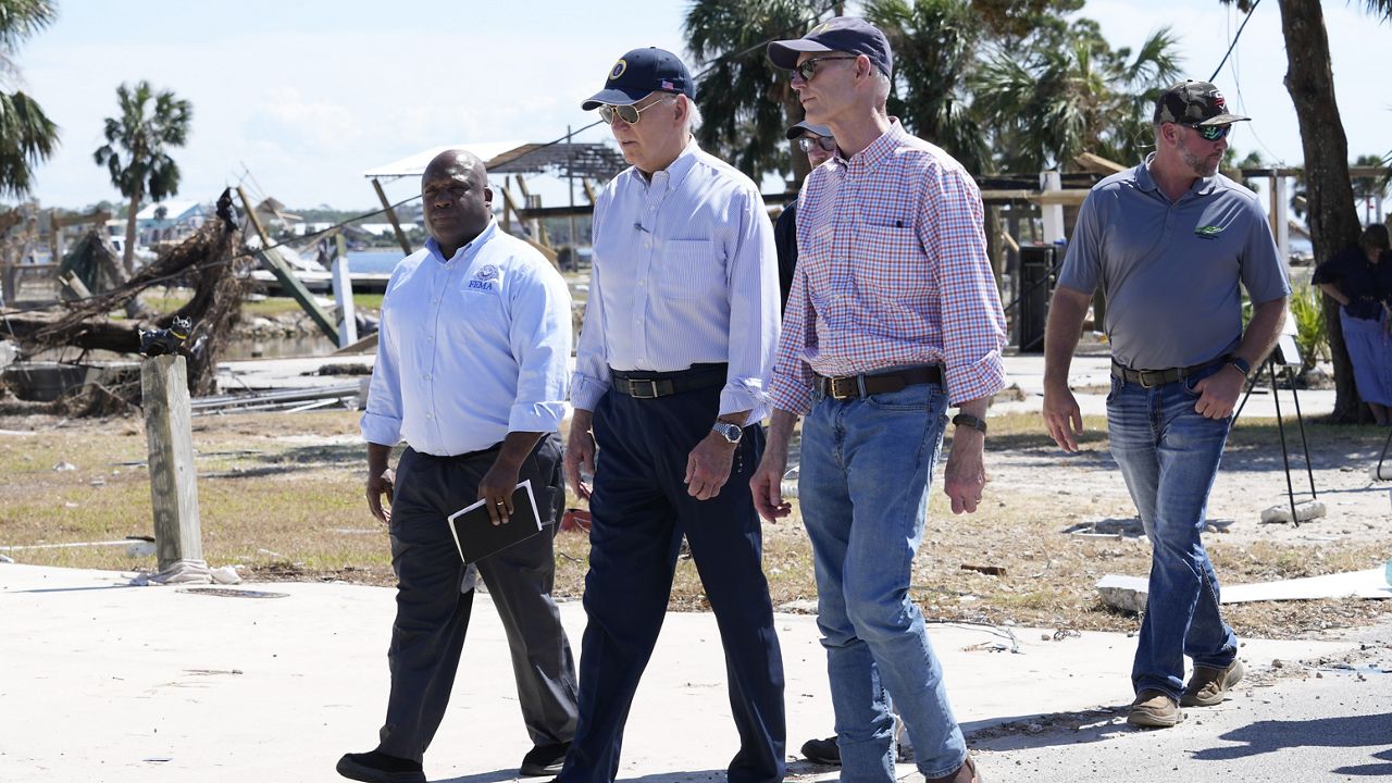 President Joe Biden, Sen. Rick Scott, R-Fla., right, and Deputy Administrator Erik Hooks, Federal Emergency and Management Agency, left, walk and view damage from Hurricane Helene in Keaton Beach, Fla., Thursday, Oct. 3, 2024. (AP Photo/Susan Walsh)