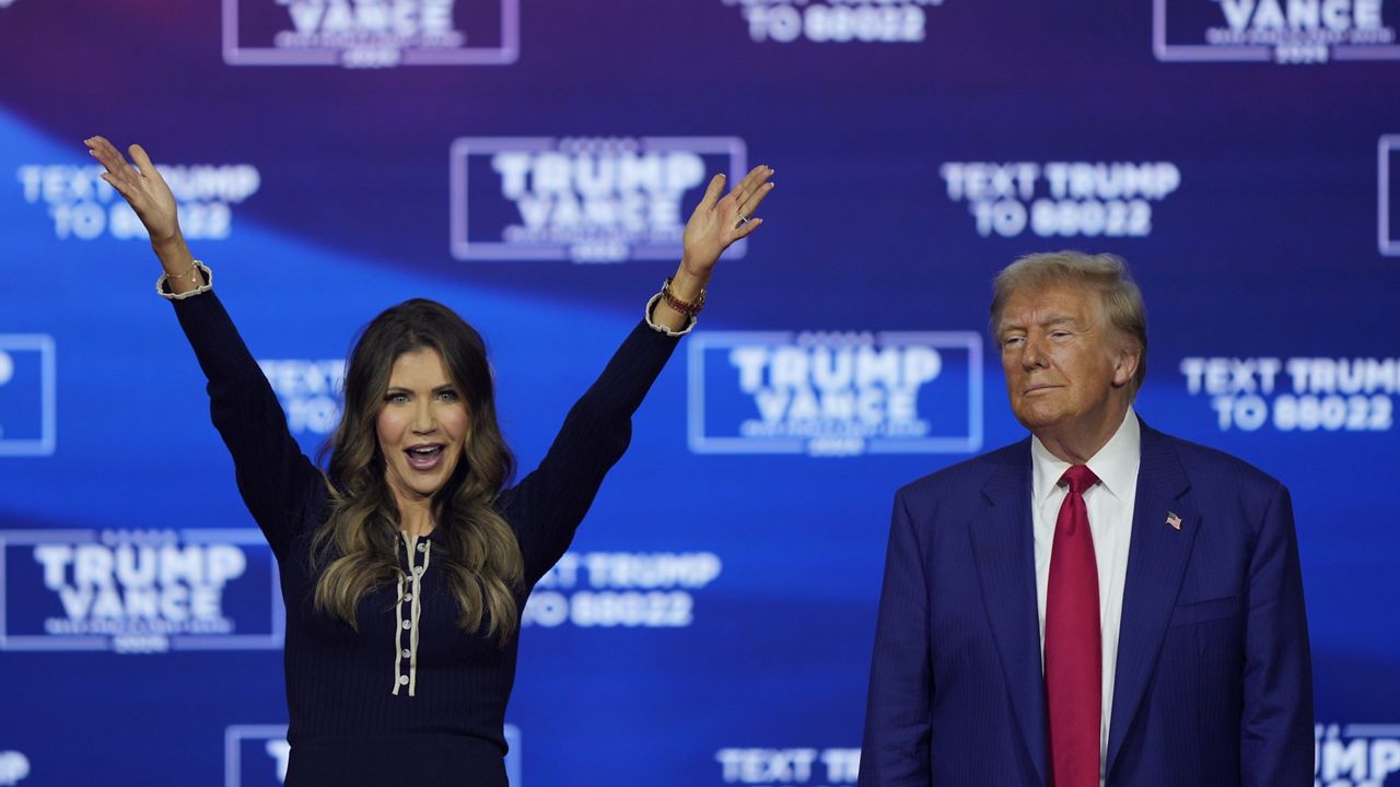 Republican presidential nominee former President Donald Trump and South Dakota Gov. Kristi Noem dance to the song "Y.M.C.A." at a campaign town hall at the Greater Philadelphia Expo Center & Fairgrounds, Monday, Oct. 14, 2024, in Oaks, Pa. (AP Photo/Matt Rourke)