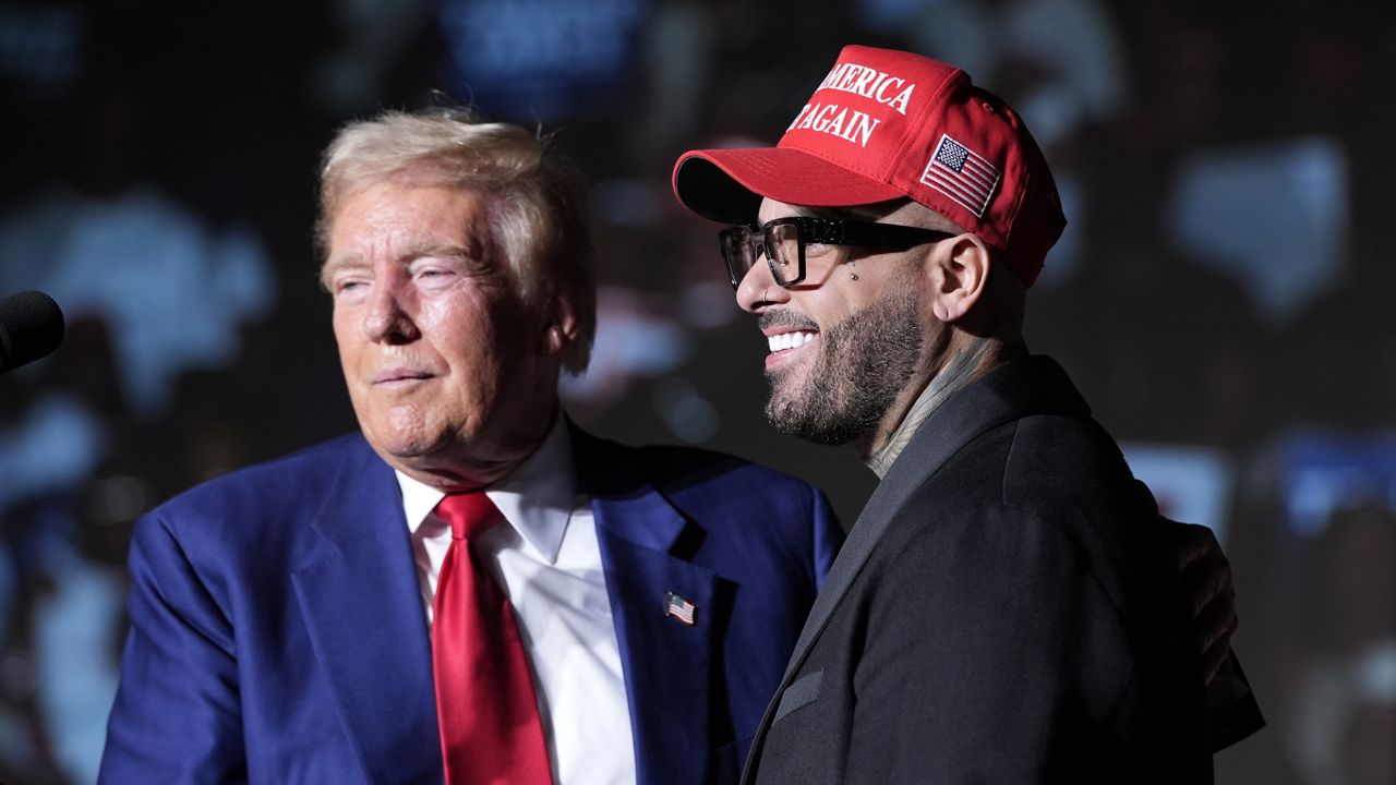 Republican presidential nominee former President Donald Trump, left, greets Nicky Jam during a campaign event at the World Market Center, Friday, Sept.13, 2024, in Las Vegas. (AP Photo/Alex Brandon)