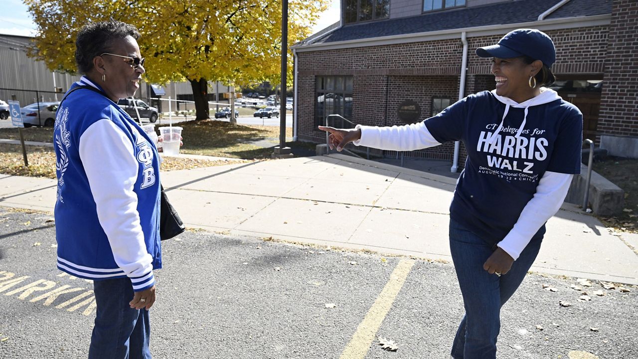 Linda Chapman of Waterbury, left, a member of the Zeta Phi Beta Sorority, Inc., talks with U.S. Rep. Jahana Hayes, D-Conn. at a Souls to the Polls voting rally at Grace Baptist Church Saturday, Oct. 26, 2024, in Waterbury, Conn. (AP Photo/Jessica Hill)