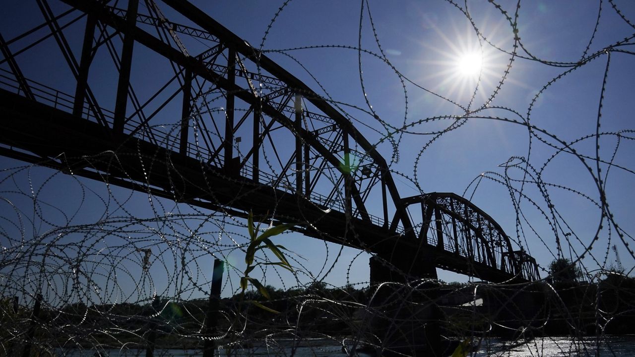 The Union Pacific International Railroad Bridge is seen behind concertina wire, Friday, Sept. 22, 2023, in Eagle Pass, Texas. (AP Photo/Eric Gay)