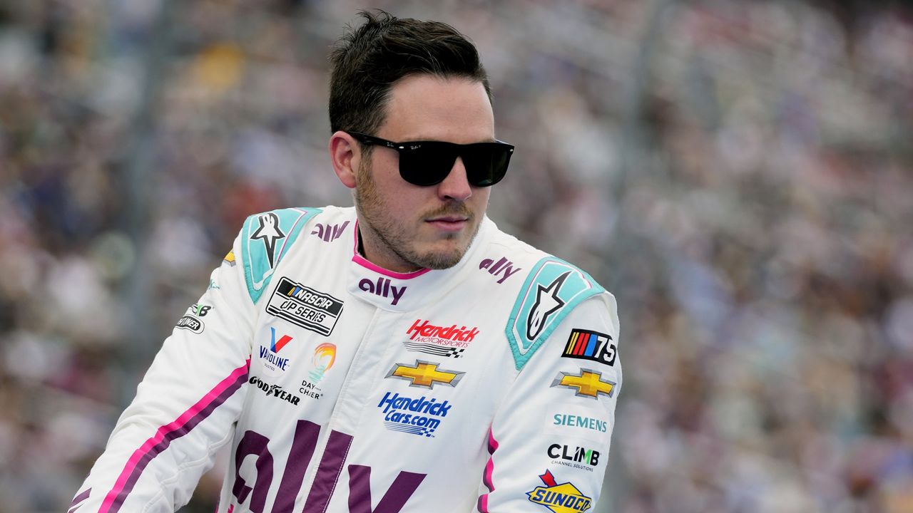 Alex Bowman looks on during driver introductions before the NASCAR Daytona 500 auto race at Daytona International Speedway, Sunday, Feb. 19, 2023, in Daytona Beach, Fla. Bowman has been cleared to return to racing this weekend for the Coca-Cola 600 at Charlotte Motor Speedway after missing four events with a fractured vertebra. (AP Photo/John Raoux)