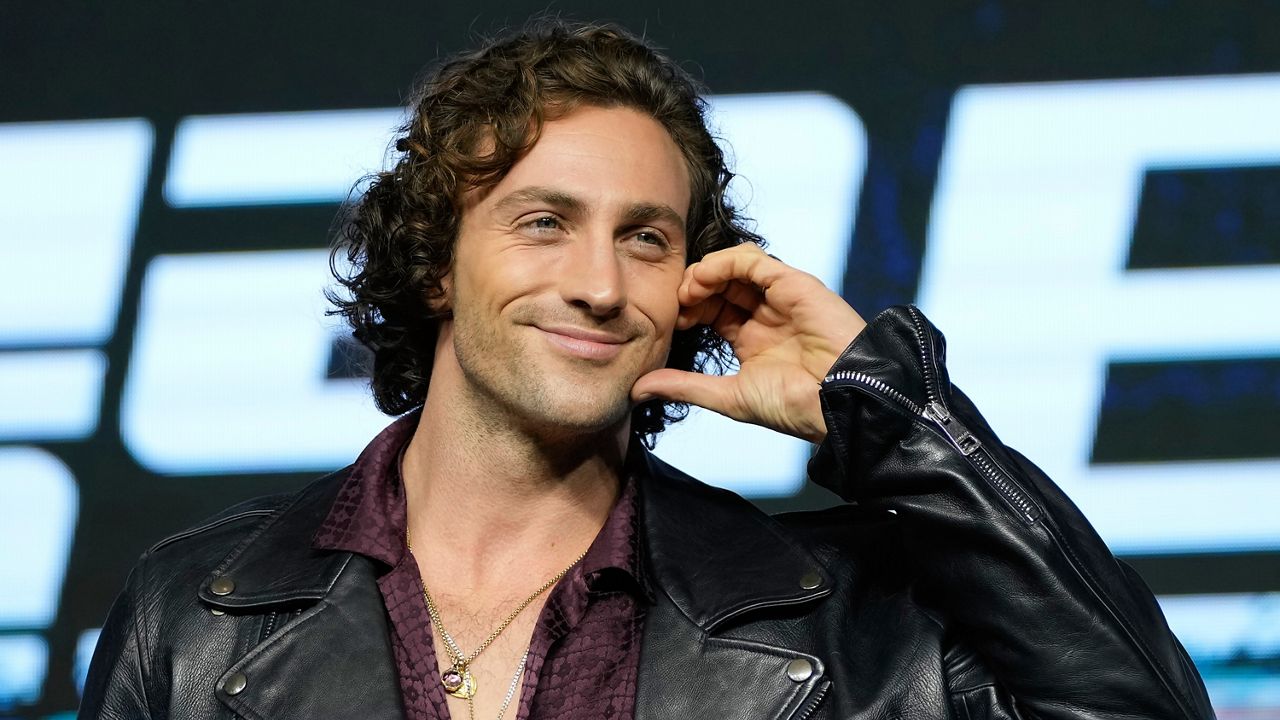 Actor Aaron Taylor-Johnson gestures as he poses for the media before the news conference to promote his latest movie "Bullet Train" in Seoul, South Korea on Aug. 19, 2022. (AP Photo/Lee Jin-man, File)