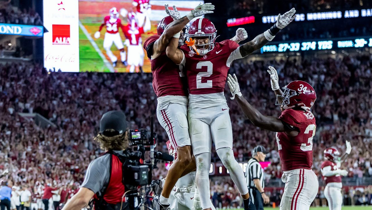 Alabama defensive back Domani Jackson, left, celebrates with defensive back Zabien Brown (2) and linebacker Que Robinson (34) after Brown intercepted a pass in the final minute during the second half of an NCAA college football game against Georgia, Saturday, Sept. 28, 2024, in Tuscaloosa, Ala. (AP Photo/Vasha Hunt)