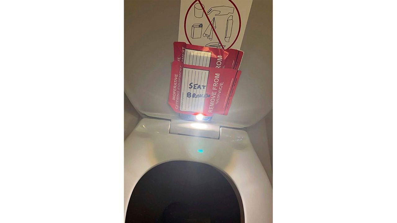 In this photo provided by the law firm Lewis & Llewellyn LLP, an iPhone is taped to the back of a toilet seat on an American Airlines flight from Charlotte, N.C., to Boston, Sept. 2, 2023. Estes Carter Thompson III, an American Airlines flight attendant arrested on suspicion of trying to secretly record a 14-year-old female passenger using an airplane bathroom last September 2023, is being held in custody until his trial.(Lewis & Llewellyn LLP via AP, File)