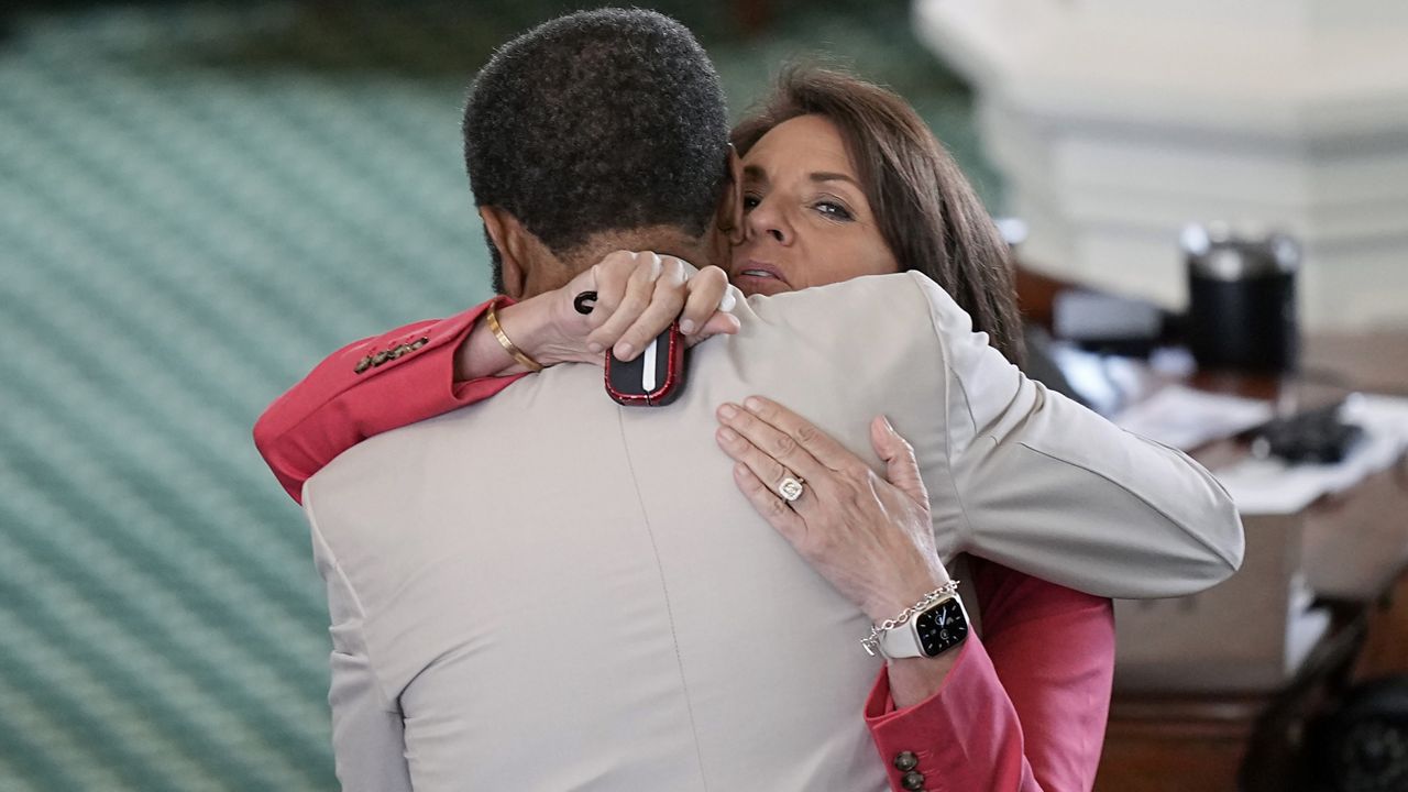 Texas State Sen. Angela Paxton, right, receives a supportive hug from Sen. Borris Miles during a break of the impeachment trial for Texas Attorney General Ken Paxton, her husband, in the Senate Chamber at the Texas Capitol, Monday, Sept. 11, 2023, in Austin, Texas. (AP Photo/Eric Gay)