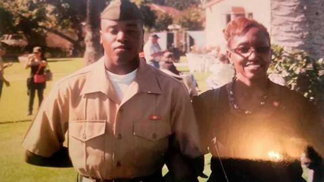 This photo shows Anthony Johnson Jr. and his mother Jacqualyne at the Marine Core graduation in Miramar, San Diego, Calif., during the fall of 2012. (Anthony Johnson Sr. via AP)
