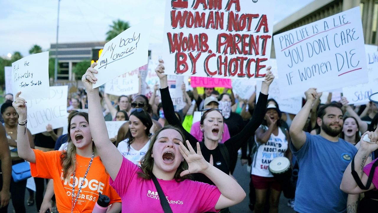 Protesters join thousands marching around the Arizona Capitol in Phoenix, protesting the U.S. Supreme Court's decision to overturn Roe v. Wade, June 24, 2022. (AP Photo/Ross D. Franklin)