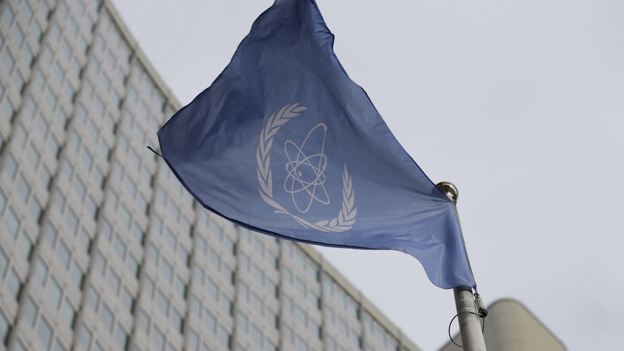 The flag of the International Atomic Energy Agency flies in front of its headquarters during an IAEA Board of Governors meeting in Vienna, Austria, on Feb. 6, 2023. (AP Photo/Heinz-Peter Bader)