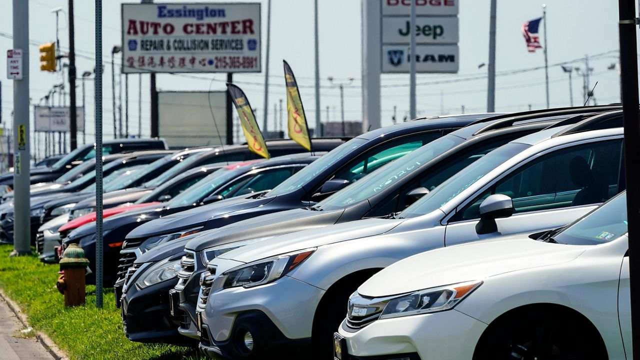 Used cars for sale are parked roadside at an auto lot in Philadelphia, Tuesday, July 12, 2022. (AP Photo/Matt Rourke)