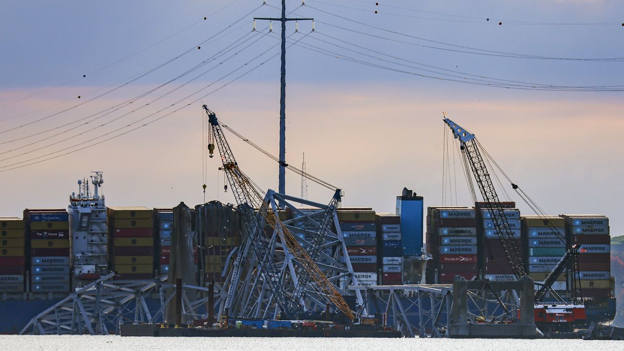 Workers start to remove a section of the collapsed Francis Scott Key Bridge, Sunday, March 31, 2024, in Baltimore. (AP Photo/Julia Nikhinson)