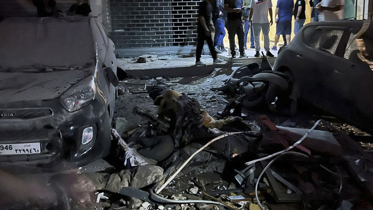 People inspect damaged cars in the southern suburbs of Beirut, Lebanon, Tuesday, July 30, 2024. (AP Photo/Hussein Malla)