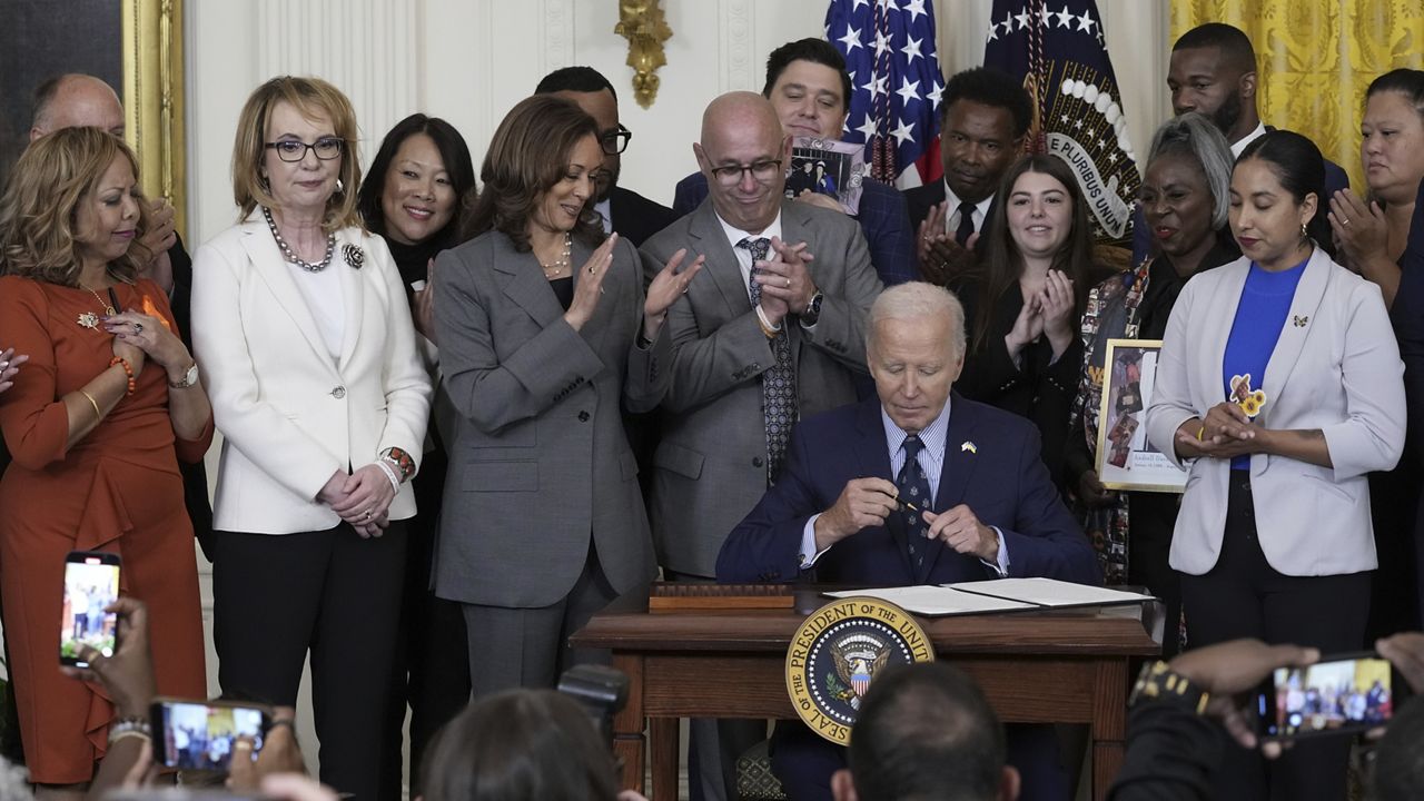 President Joe Biden signs an executive order that aims to help schools make active shooter drills less traumatic for students yet still effective, during an event with Vice President Kamala Harris and others in the East Room of the White House in Washington, Thursday, Sept. 26, 2024, on gun violence in the United States. (AP Photo/Susan Walsh)