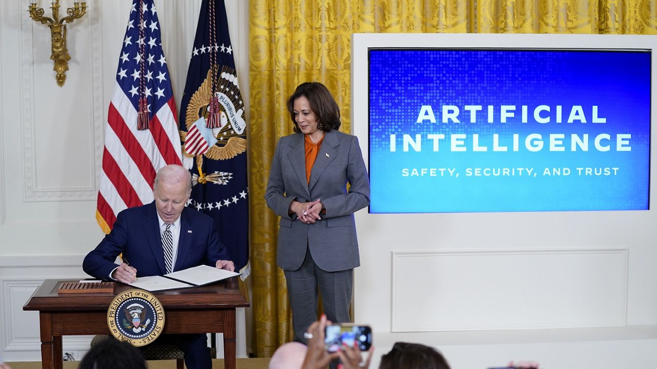 President Joe Biden signs an executive on artificial intelligence in the East Room of the White House, Monday, Oct. 30, 2023, in Washington. Vice President Kamala Harris looks on at right. (AP Photo/Evan Vucci, File)