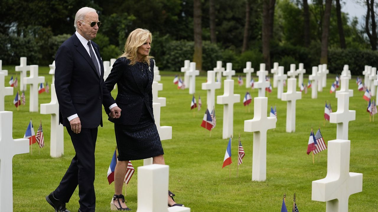 President Joe Biden and first lady Jill Biden walk in the Normandy American Cemetery following a ceremony to mark the 80th anniversary of D-Day, Thursday, June 6, 2024, in Normandy. (AP Photo/Evan Vucci)