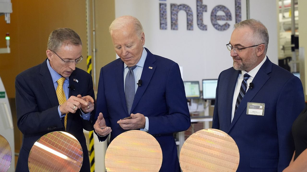 President Joe Biden listens to Intel CEO Pat Gelsinger, left, as Intel factory manager Hugh Green listens, during a tour of the Intel Ocotillo Campus, in Chandler, Ariz., Wednesday March 20, 2024. (AP Photo/Jacquelyn Martin)