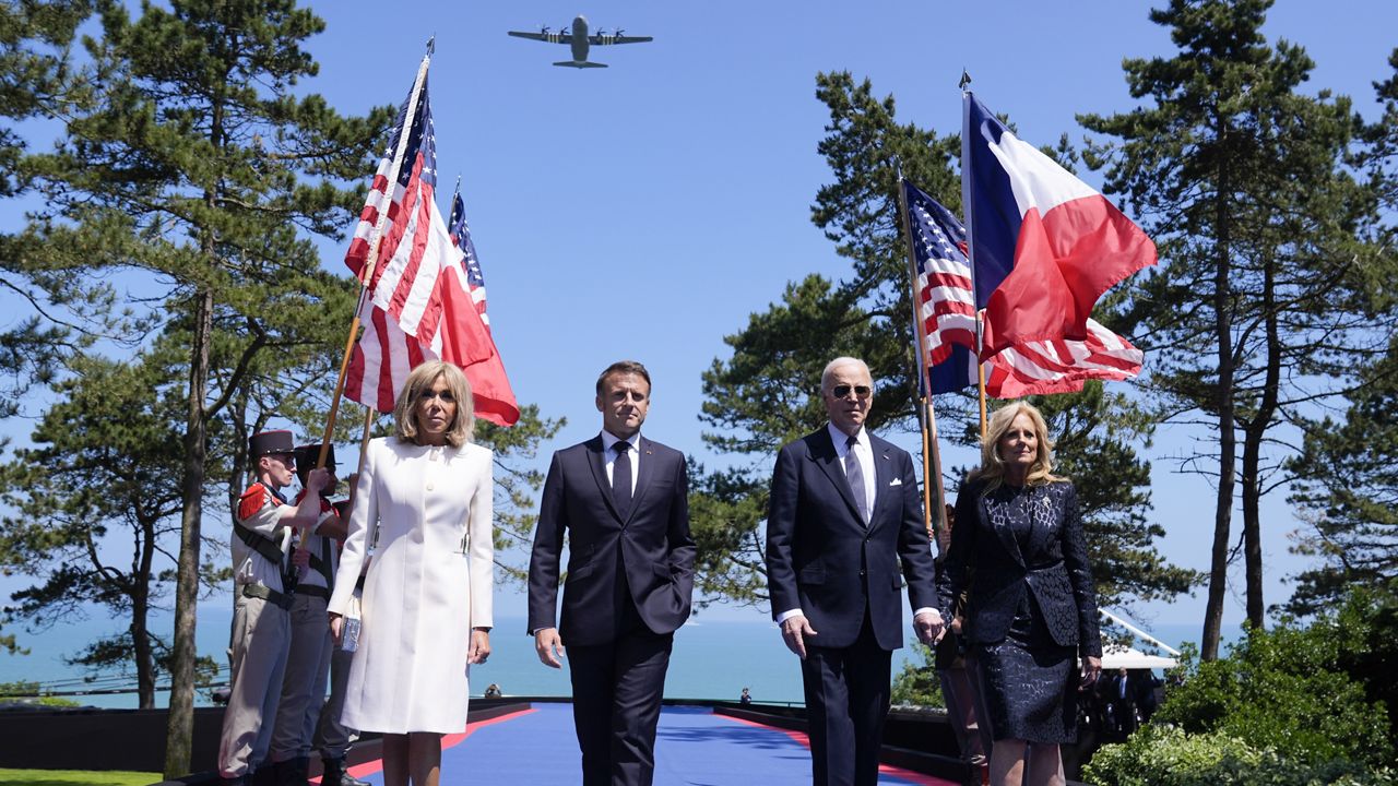 President Joe Biden, first lady Jill Biden, French President Emmanuel Macron, his wife Brigitte Macron, walk on stage during ceremonies to mark the 80th anniversary of D-Day, Thursday, June 6, 2024, in Normandy. (AP Photo/Evan Vucci)