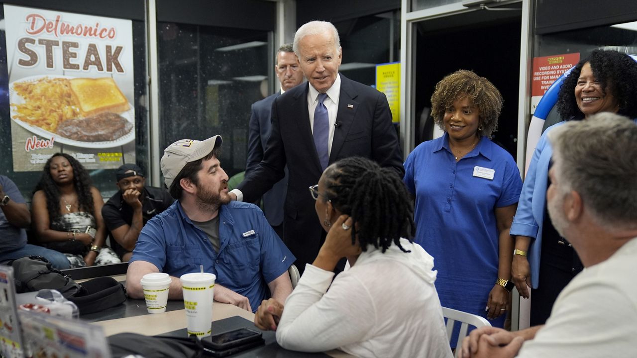 President Joe Biden, center, greet supporters at a Waffle House in Marietta, Ga., Friday, June 28, 2024, following a presidential debate in Atlanta. (AP Photo/Evan Vucci)
