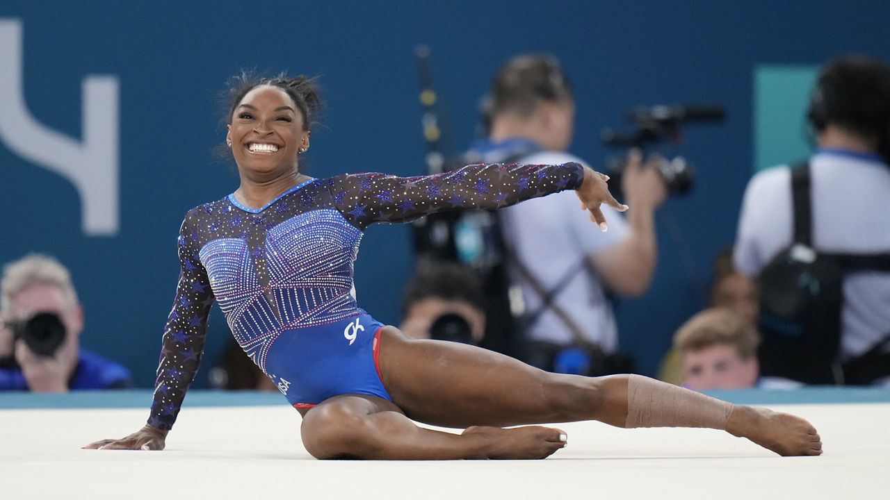 Simone Biles, of the United States, performs on the floor during the women's artistic gymnastics all-around finals in Bercy Arena at the 2024 Summer Olympics, Thursday, Aug. 1, 2024, in Paris, France. (AP Photo/Natacha Pisarenko)