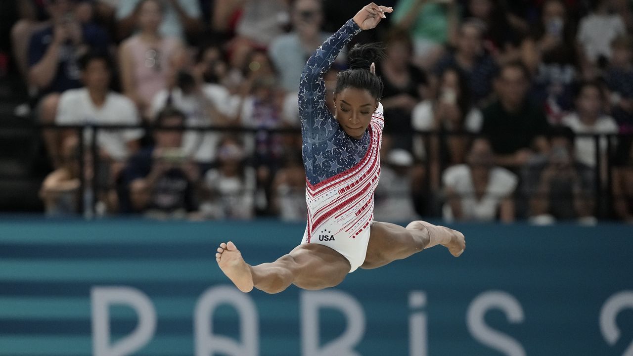 Simone Biles, of the United States, performs on the balance beam during the women's artistic gymnastics team finals round at Bercy Arena at the 2024 Summer Olympics, Tuesday, July 30, 2024, in Paris, France. (AP Photo/Natacha Pisarenko)