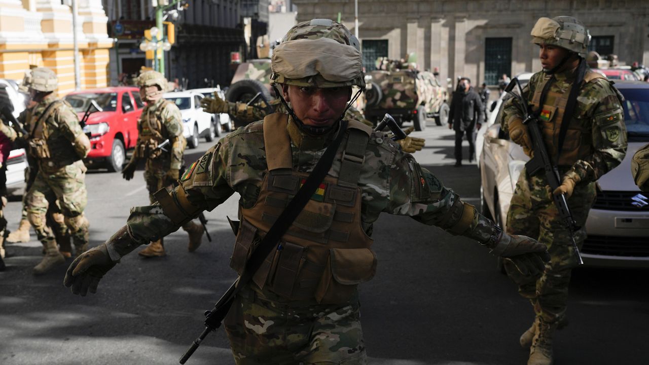 A soldier gestures for journalists to leave Plaza Murillo as soldiers gather outside the presidential palace in Plaza Murillo in La Paz, Bolivia, Wednesday, June 26, 2024. (AP Photo/Juan Karita)