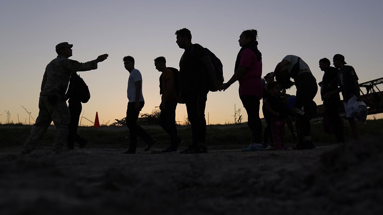 Migrants who crossed the Rio Grande and entered the U.S. from Mexico are lined up for processing by U.S. Customs and Border Protection, Sept. 23, 2023, in Eagle Pass, Texas. (AP Photo/Eric Gay)