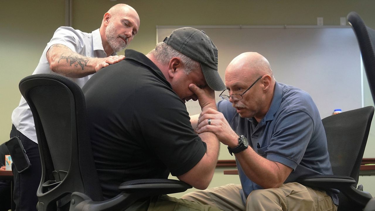 Border Patrol specialist Mitchell Holmes, right, and Fish and Wildlife Regional Law Enforcement agent Kevin Shinn, use skills they learned in the Border Patrol Chaplaincy academy during a training session, Wednesday, Nov. 20, 2024, in Dania Beach, Fla. (AP Photo/Marta Lavandier)