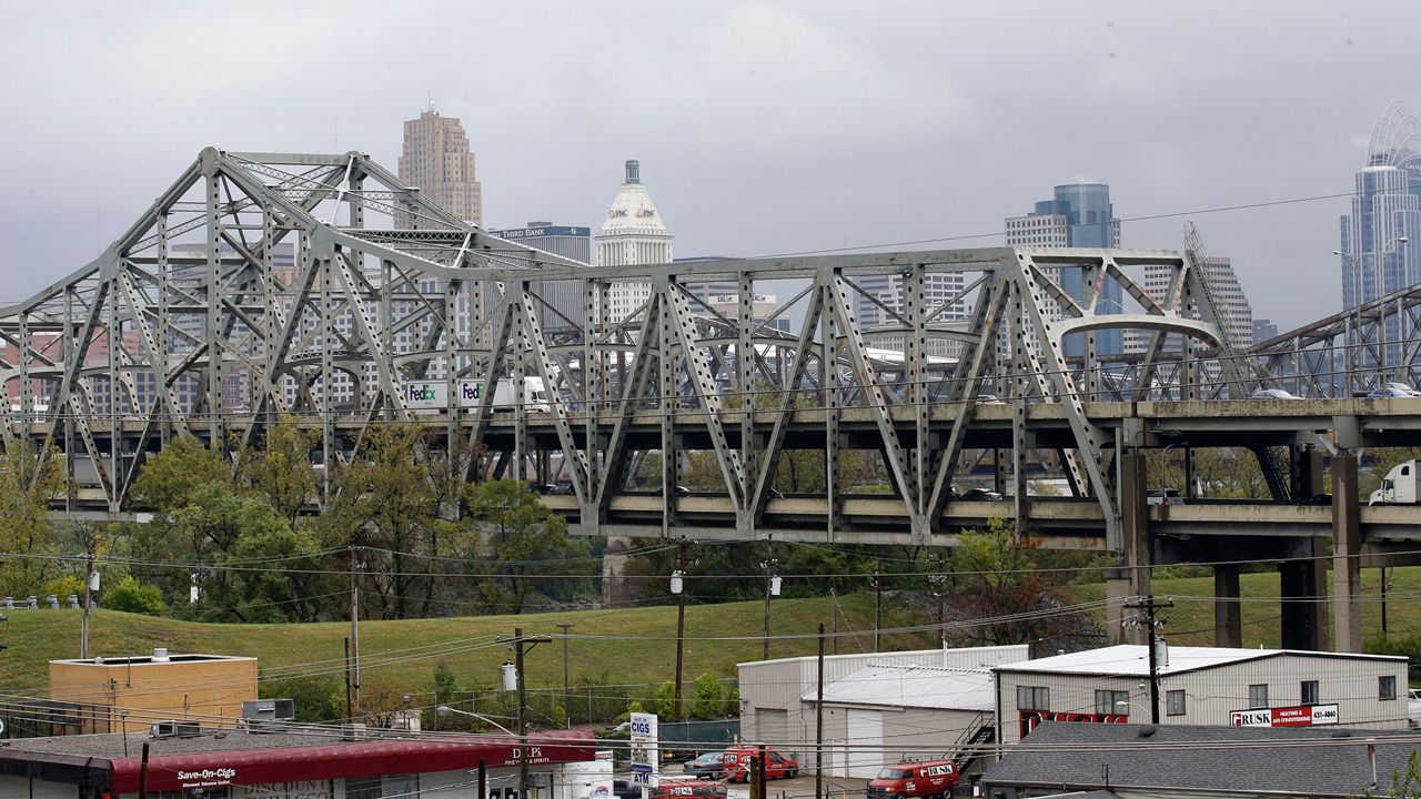 Traffic on the Brent Spence Bridge passes in front of the Cincinnati skyline while crossing the Ohio River to and from Covington, Ky., Oct. 7, 2014. According to a recent announcement by Kentucky and Ohio they will receive more than $1.63 billion in federal grants to help build a new Ohio River bridge near Cincinnati and improve the existing overloaded span there, a heavily used freight route linking the Midwest and the South. (AP Photo/Al Behrman, File)