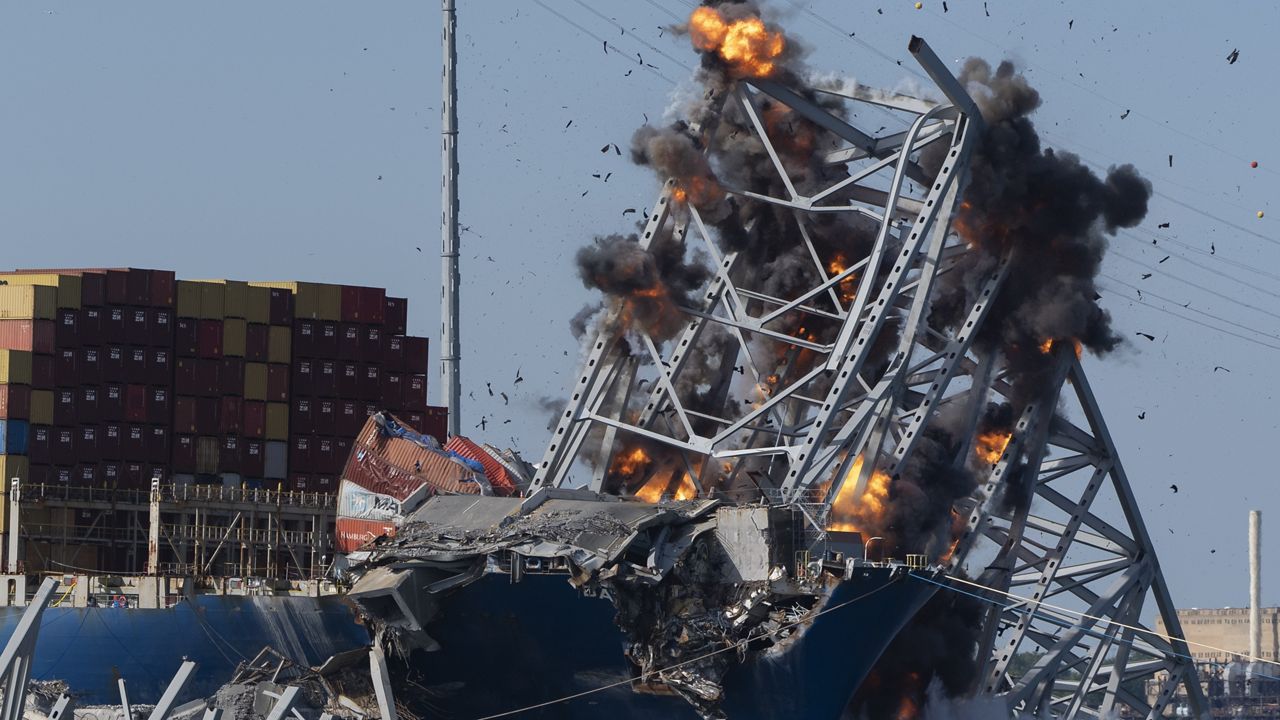 Explosive charges are detonated to bring down sections of the collapsed Francis Scott Key Bridge resting on the container ship Dali on Monday, May 13, 2024, in Baltimore. (AP Photo/Mark Schiefelbein)