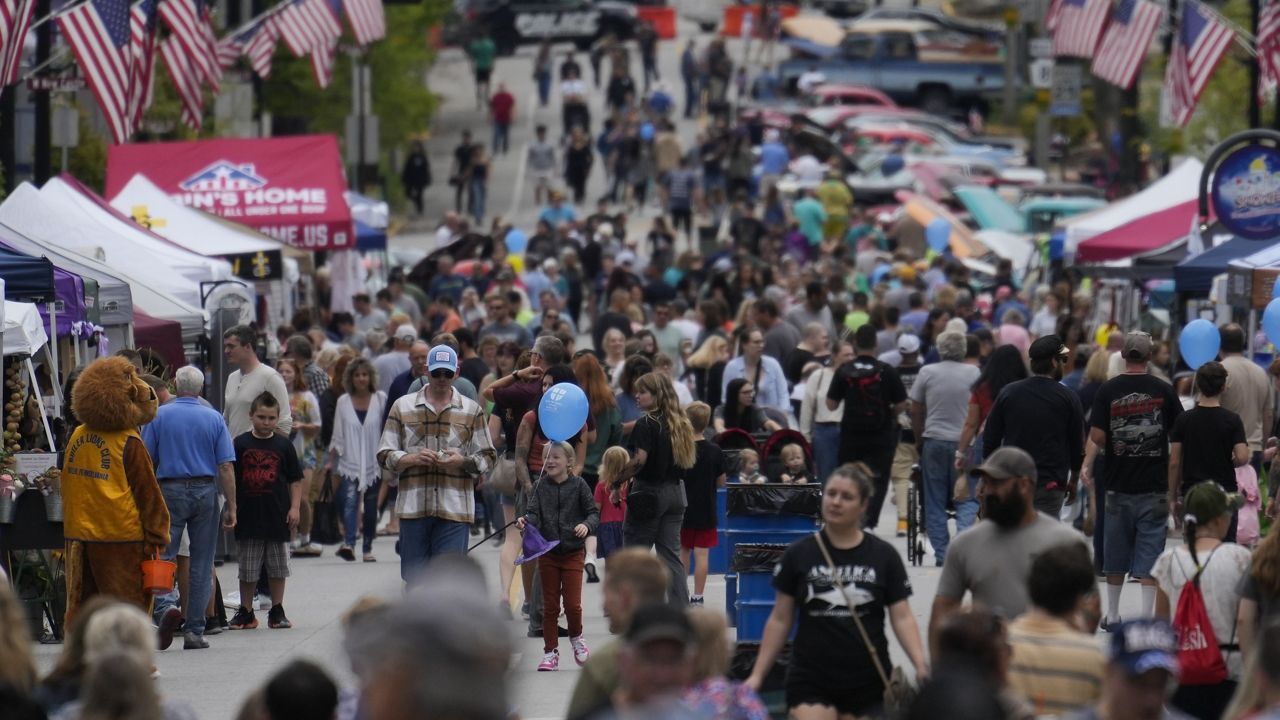 People attend the Butler Fall Festival in Butler, Saturday, Sept. 28, 2024. (AP Photo/Matt Rourke)