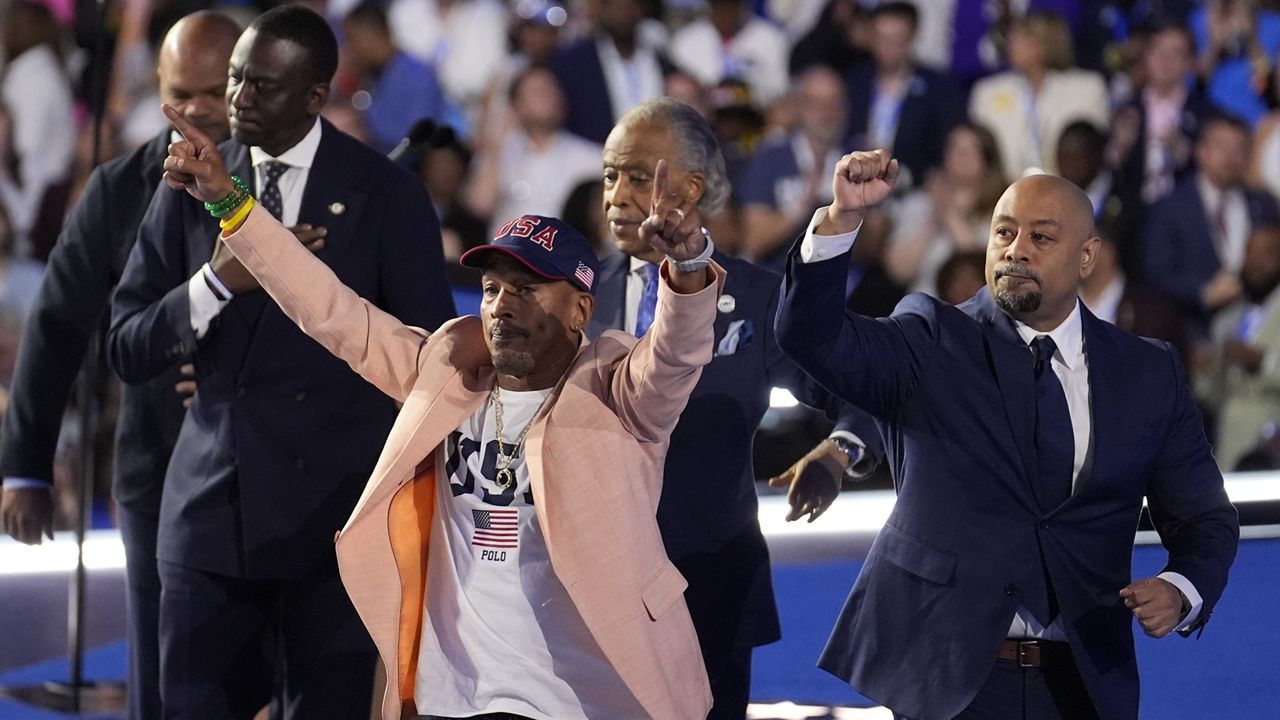 The Central Park Five join Reverend Al Sharpton during the Democratic National Convention Thursday, Aug. 22, 2024, in Chicago. (AP Photo/Charles Rex Arbogast)