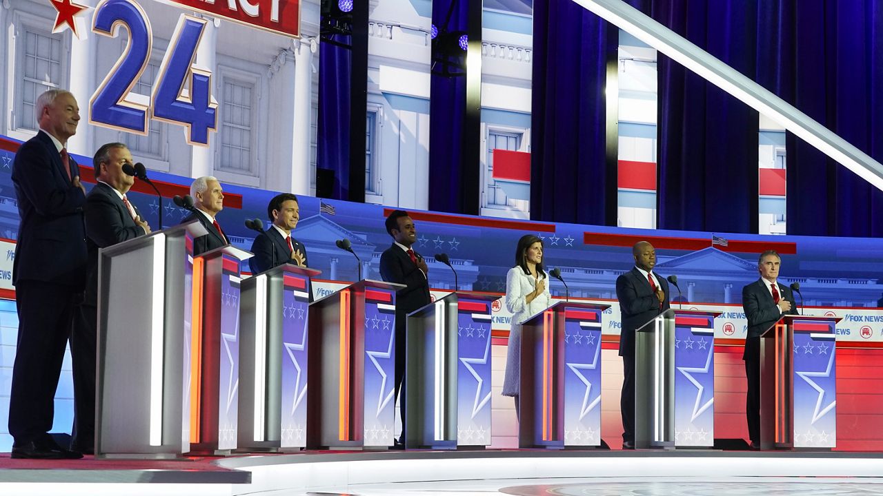 Republican presidential candidates, from left, former Arkansas Gov. Asa Hutchinson, former New Jersey Gov. Chris Christie, former Vice President Mike Pence, Florida Gov. Ron DeSantis, businessman Vivek Ramaswamy, former U.N. Ambassador Nikki Haley, Sen. Tim Scott, R-S.C., and North Dakota Gov. Doug Burgum stand on stage before a Republican presidential primary debate hosted by FOX News Channel Wednesday, Aug. 23, 2023, in Milwaukee. (AP Photo/Morry Gash)