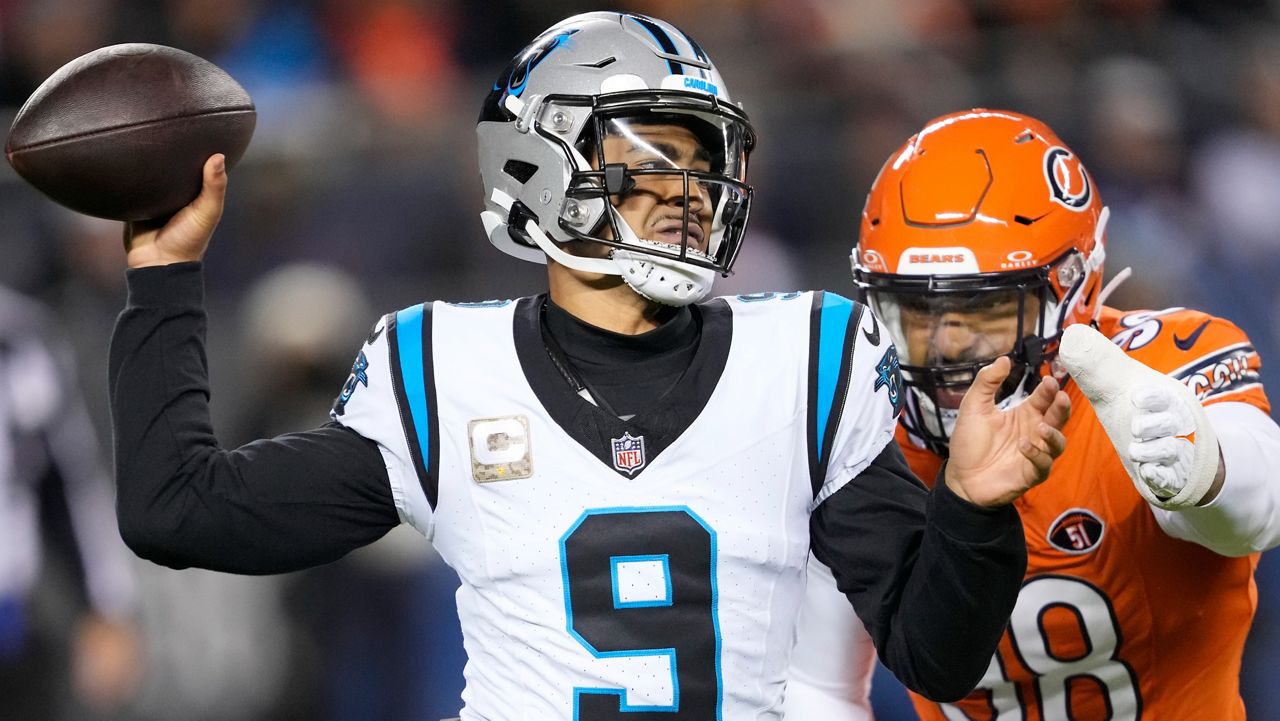 Carolina Panthers quarterback Bryce Young (9) throws under pressure from Chicago Bears defensive end Montez Sweat (98) during the first half of an NFL football game Thursday, Nov. 9, 2023, in Chicago. (AP Photo/Charles Rex Arbogast)