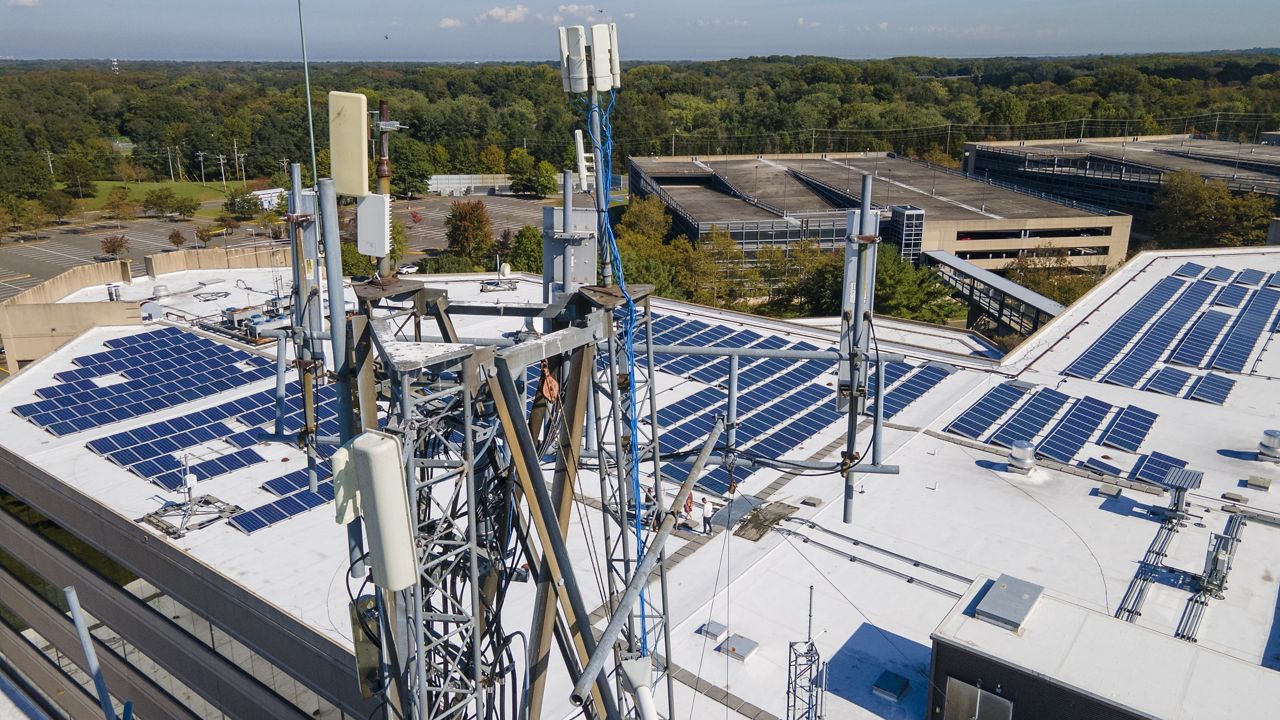 Solar panels and a cellular tower are atop AT&T Labs in Middletown Township, New Jersey, on Thursday, October 12, 2023. (AP Photo/Ted Shaffrey)
