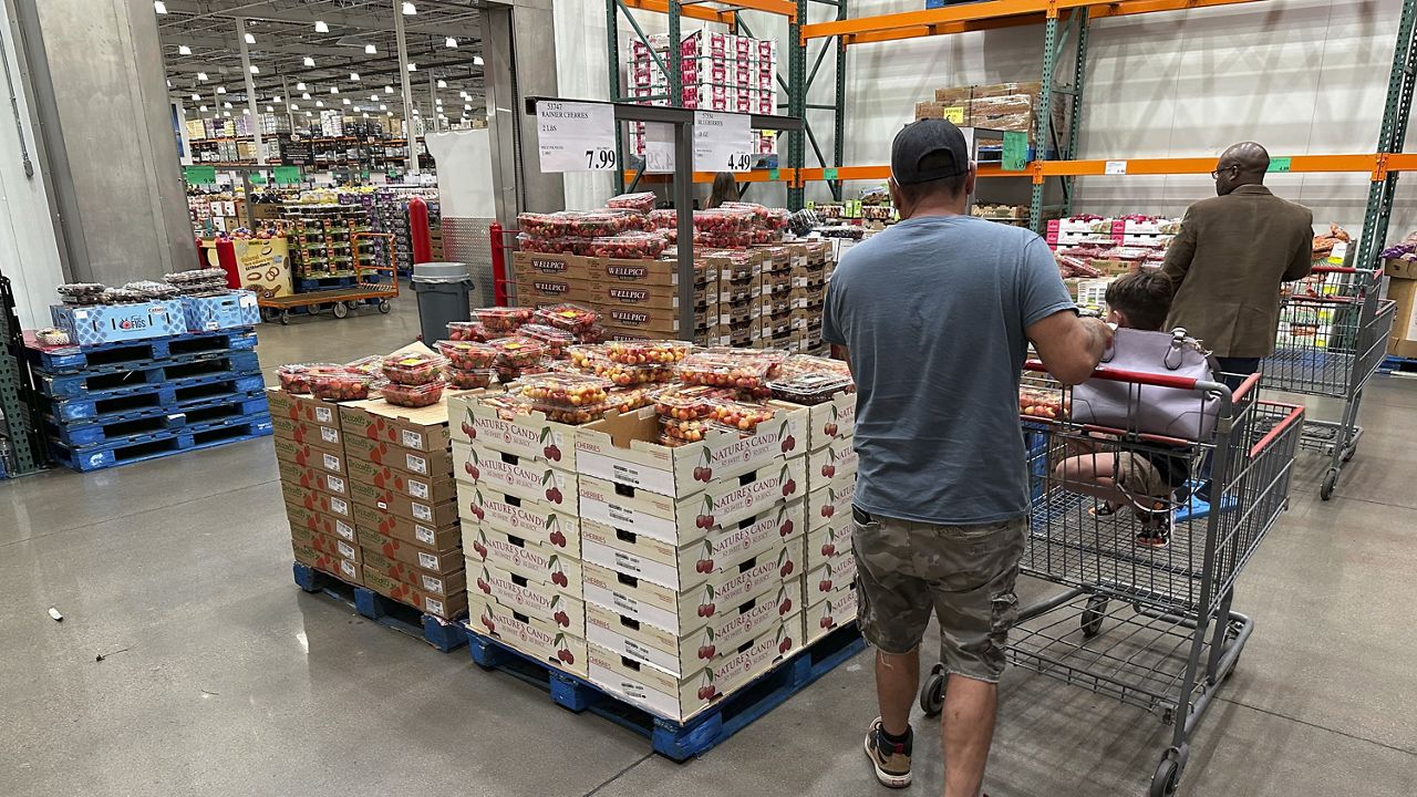 Shoppers peruse a display of Rainer cherries at a Costco warehouse Tuesday, July 11, 2023, in Sheridan, Colo. (AP Photo/David Zalubowski)