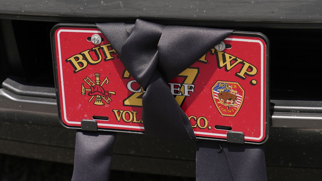 An automobile license plate at the Buffalo Township Fire Company 27 is wrapped in black bunting in Buffalo Township, Pa., Sunday, July 14, 2024. Firefighter Corey Comperatore was killed during a shooting at a campaign rally for Republican presidential candidate former President Donald Trump in Butler, Pa., on Saturday. (AP Photo/Sue Ogrocki)