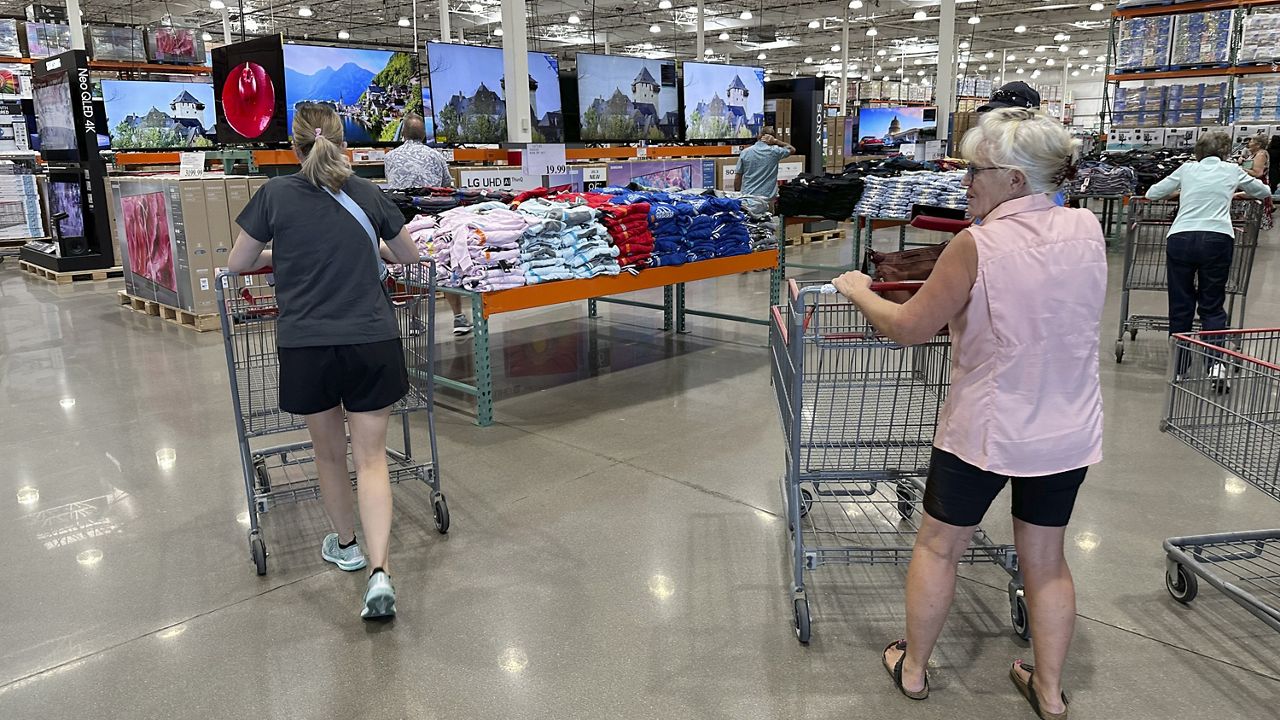Shoppers push carts into a Costco warehouse Friday, Aug. 4, 2023, in Thornton, Colo. (AP Photo/David Zalubowski)