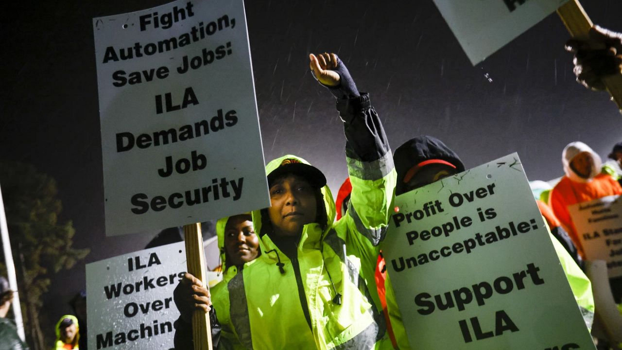 Dockworkers Meikysha Wright and others strike outside the Virginia International Gateway in Portsmouth, Va., Tuesday, Oct. 1, 2024. (Billy Schuerman/The Virginian-Pilot via AP)