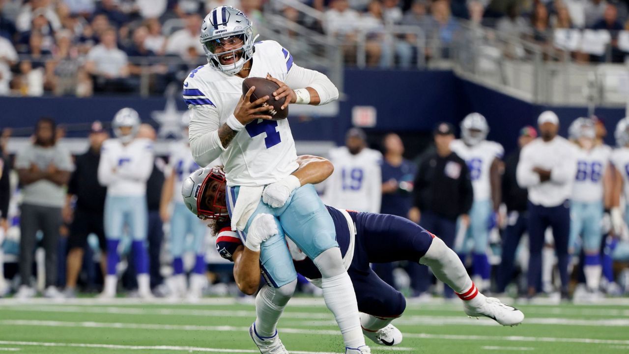 Dallas Cowboys quarterback Dak Prescott (4) is sacked by New England Patriots linebacker Jahlani Tavai, rear, in the second half of an NFL football game in Arlington, Texas, Sunday, Oct. 1, 2023. (AP Photo/Michael Ainsworth)
