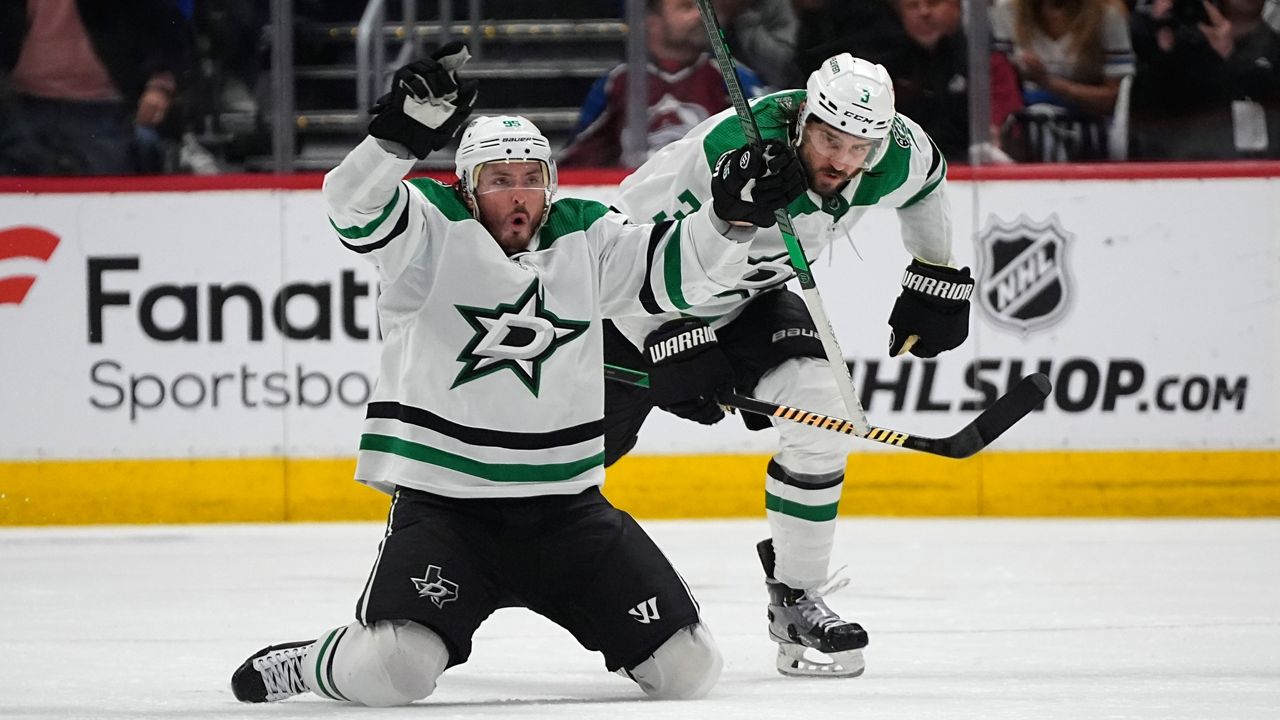 Dallas Stars center Matt Duchene, left, celebrates after scoring the winning goal with defenseman Chris Tanev. (AP Photo/David Zalubowski)