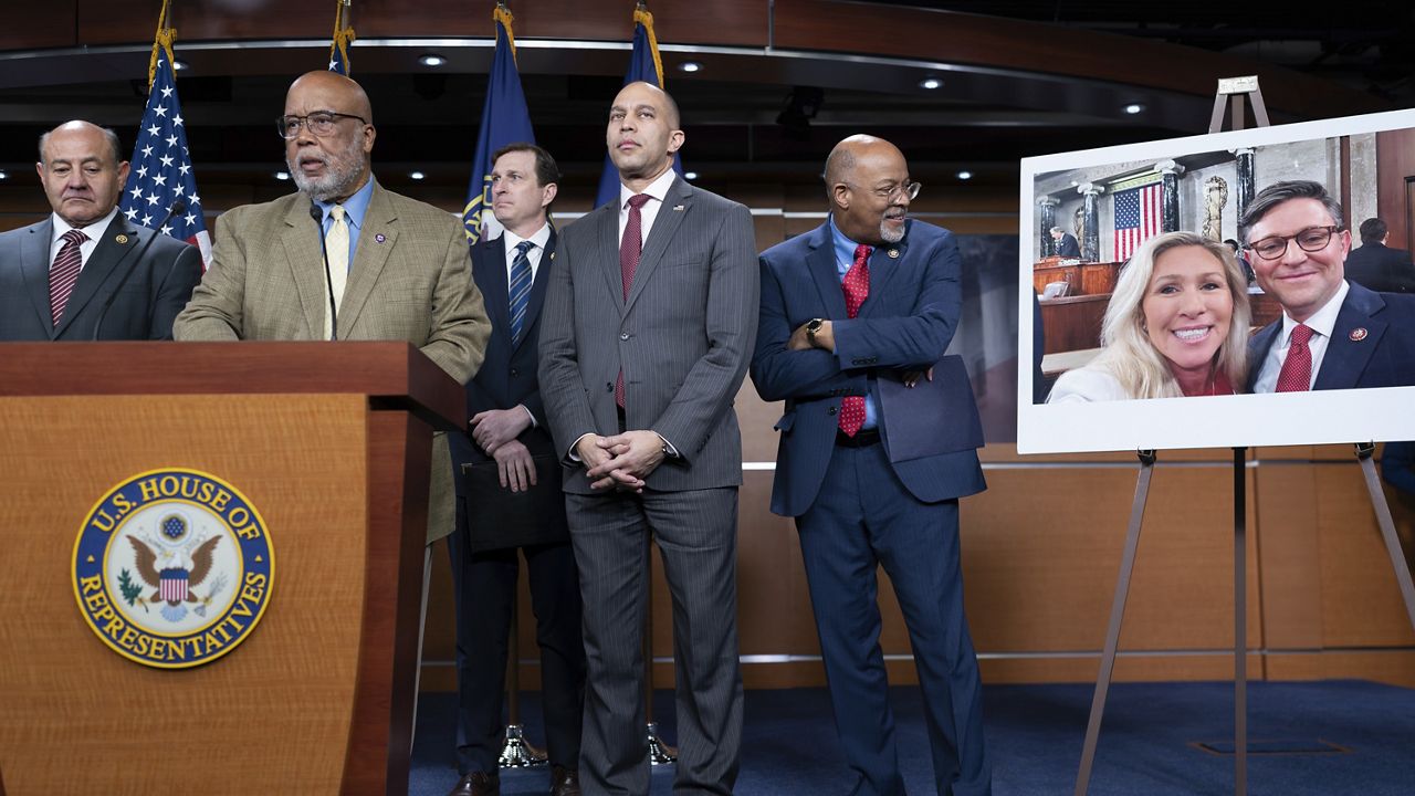 House Democrats, from left, Rep. Lou Correa, D-Calif., Rep. Bennie Thompson, D-Miss., ranking member of the House Homeland Security Committee, Rep. Dan Goldman, D-N.Y., House Minority Leader Hakeem Jeffries, D-N.Y., and Rep. Glenn Ivey D-Md., criticize House Republicans for pursuing impeachment of Secretary of Homeland Security Alejandro Mayorkas during a news conference at the Capitol in Washington, Monday, Jan. 29, 2024. At right is a photo of Rep. Marjorie Taylor Greene, R-Ga., with House Speaker Mike Johnson, R-La. (AP Photo/J. Scott Applewhite)