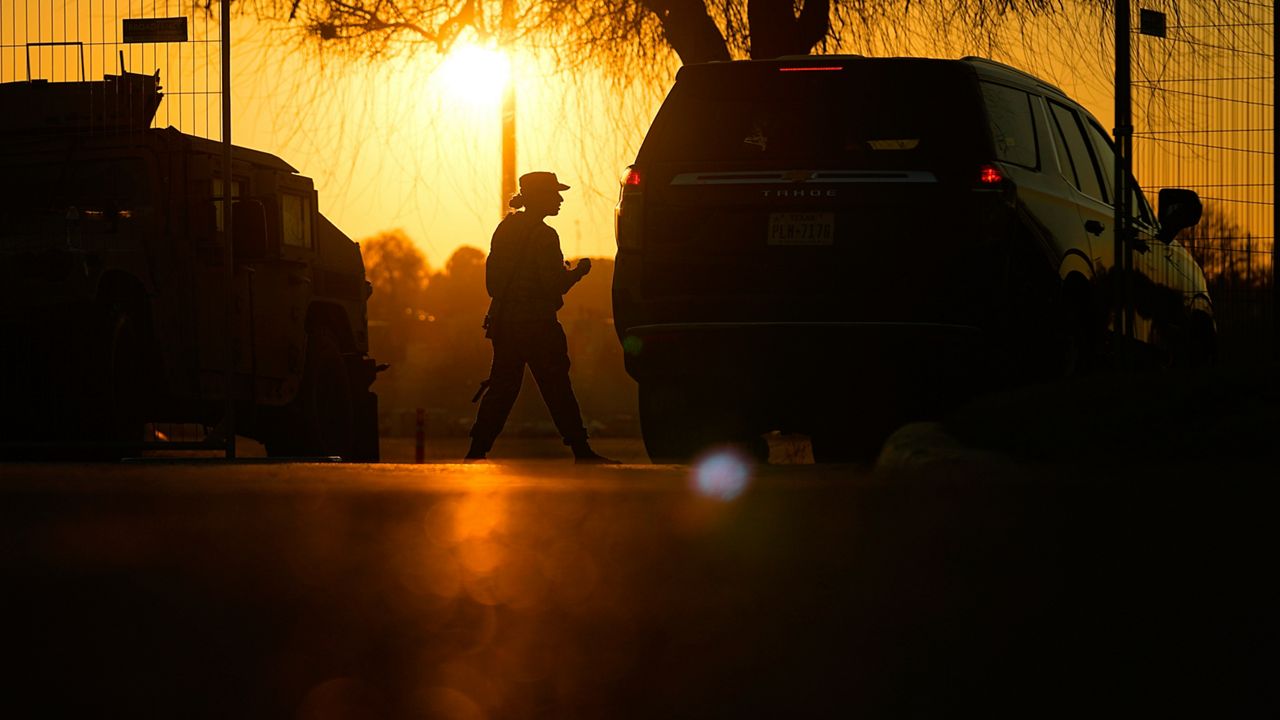 A guardsman checks a vehicle at the gate for Shelby Park, which troops from the Texas National Guard seized and began turning away federal immigration authorities, Thursday, Feb. 1, 2024, in Eagle Pass, Texas. (AP Photo/Eric Gay)