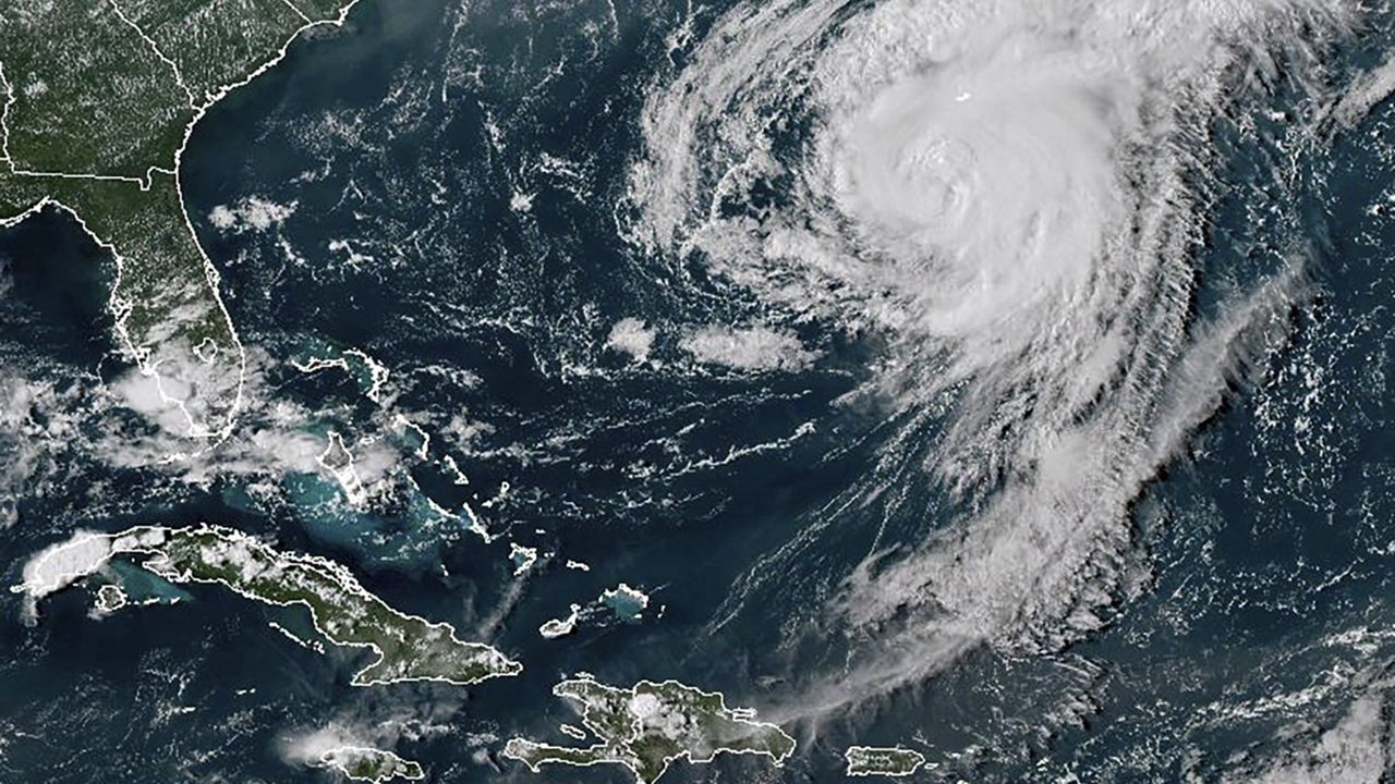 This GOES-16 GeoColor satellite image taken at 4:40 p.m EDT and provided by National Oceanic and Atmospheric Administration (NOAA) shows Hurricane Ernesto in the Atlantic Ocean south-southwest of Bermuda, Friday, Aug. 16, 2024. (NOAA via AP)