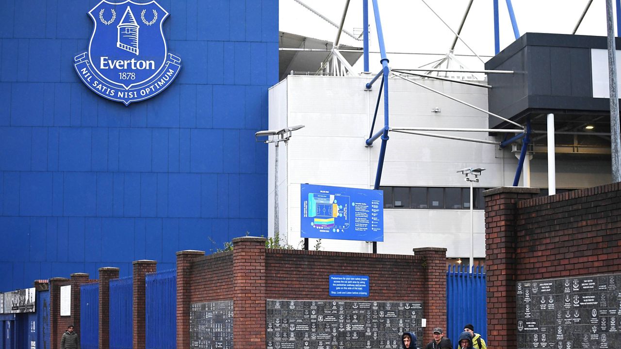 People walk outside Goodison Park as the Premier League soccer match between Everton and Liverpool is called off due to storm Darragh at Goodison Park, in Liverpool, England, Saturday Dec 7, 2024. (AP Photo/Rui Vieira)