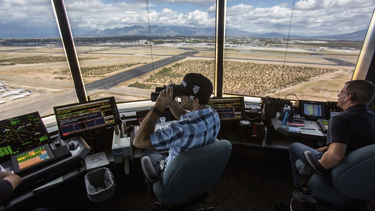 Air traffic controllers watch for traffic from the control tower at the Tucson International Airport, Friday, Sept. 23, 2016, in Tucson, Ariz. The Federal Aviation Administration said Wednesday, July 24, 2024, that it reached an agreement the union that allow air traffic controllers to get more rest between shifts. (Ron Medvescek/Arizona Daily Star via AP, File)