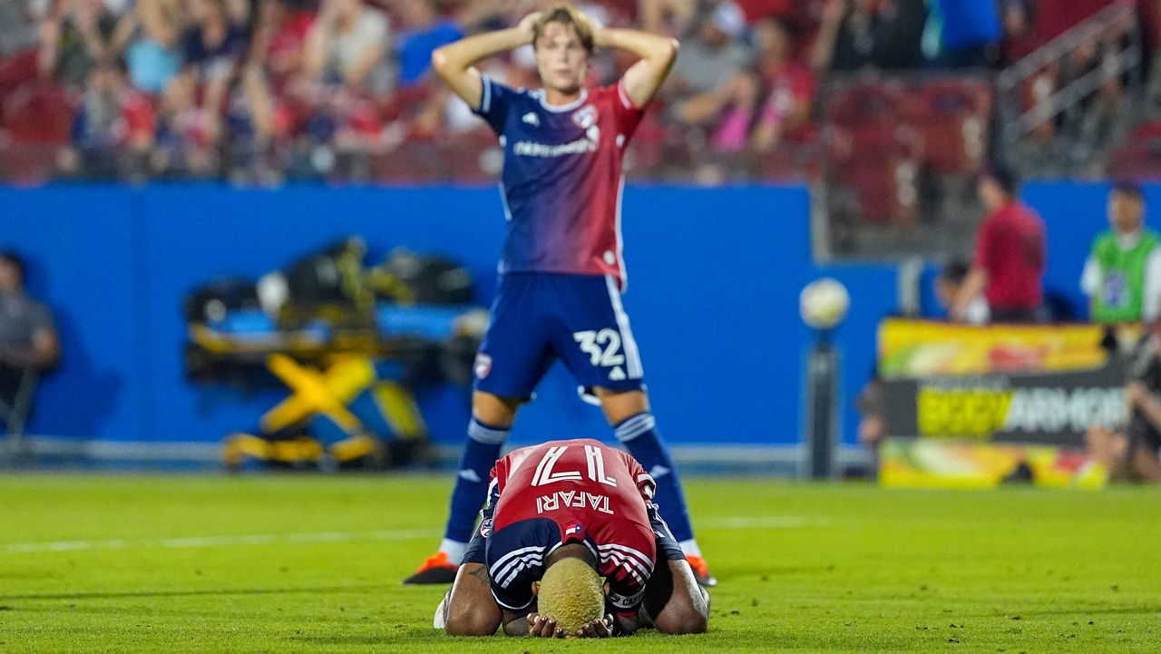 FC Dallas defender Nkosi Tafari, bottom, and defender Nolan Norris react after Real Salt Lake midfielder Nelson Palacio scored a goal in injury time to tie the score 3-3 during the second half of an MLS soccer match, Saturday, May 25, 2024, in Frisco, Texas. The teams tied 3-3. (AP Photo/Julio Cortez)